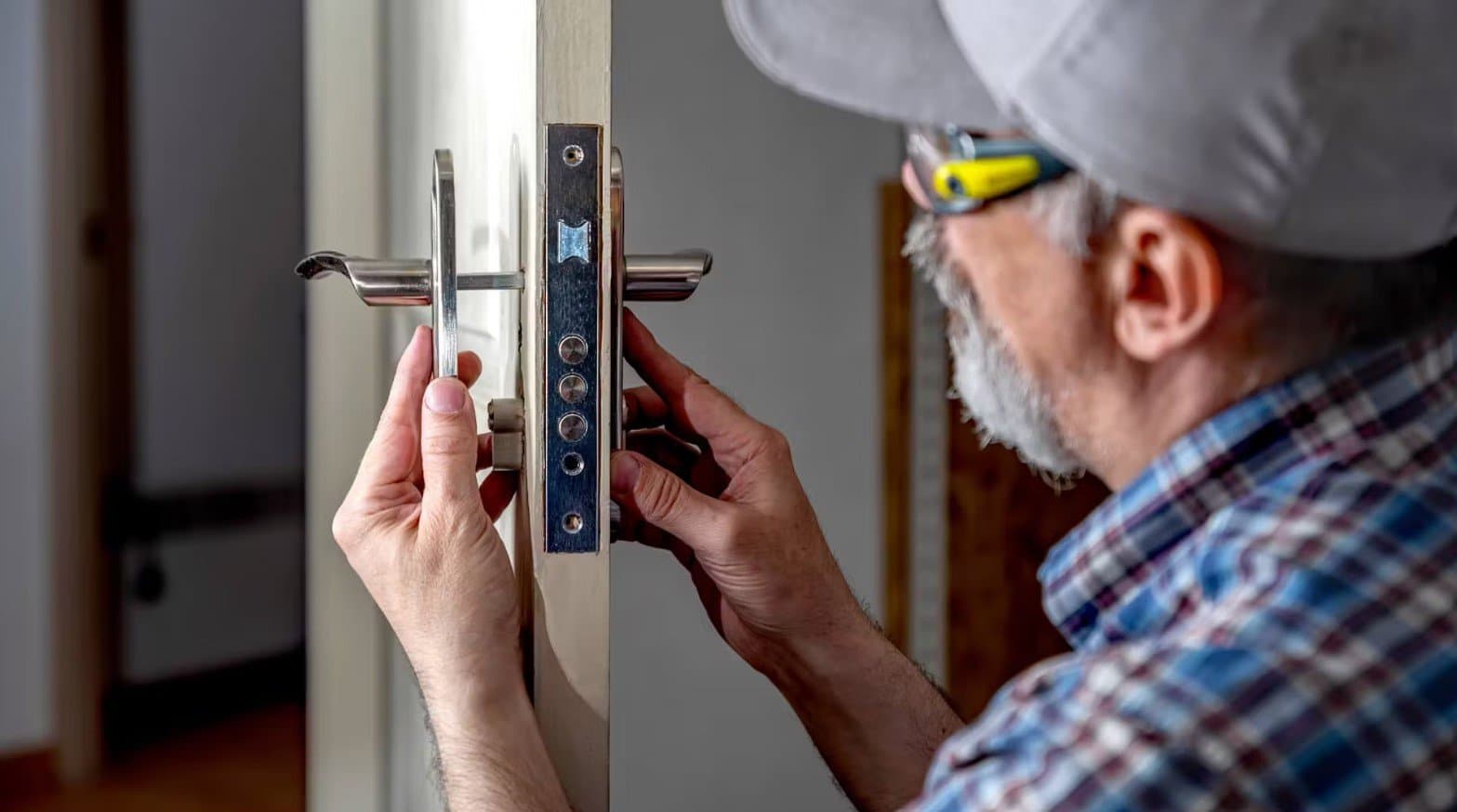 Locksmith installing a new lock