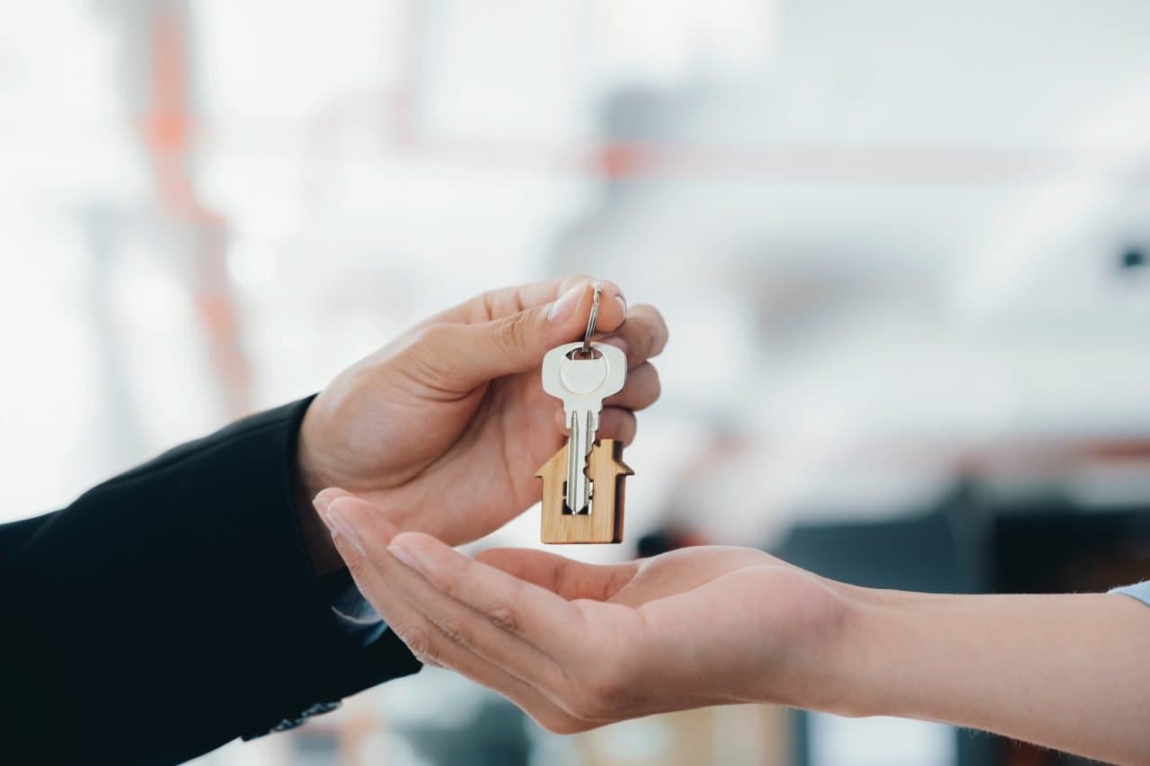 New homeowner in Westwood, MA holding house keys