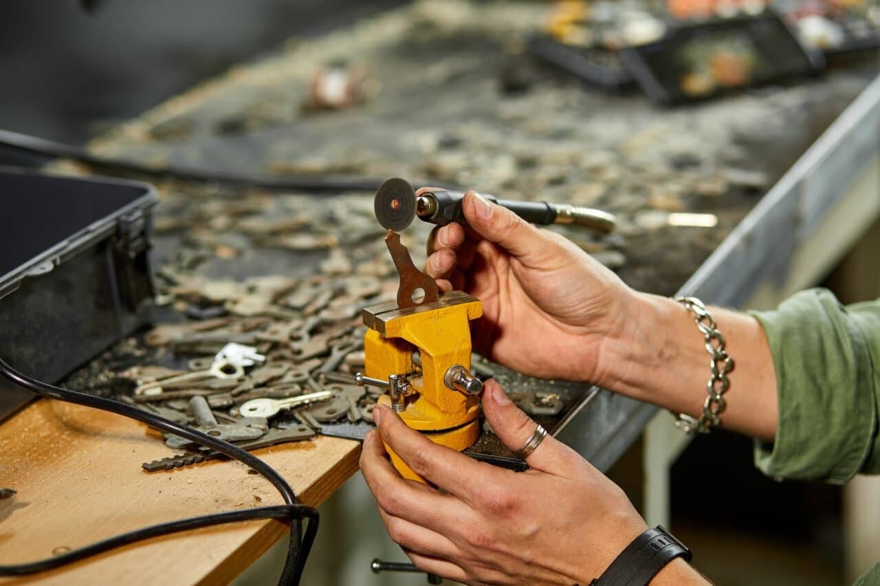 Locksmith cutting a key on a precision grinding machine